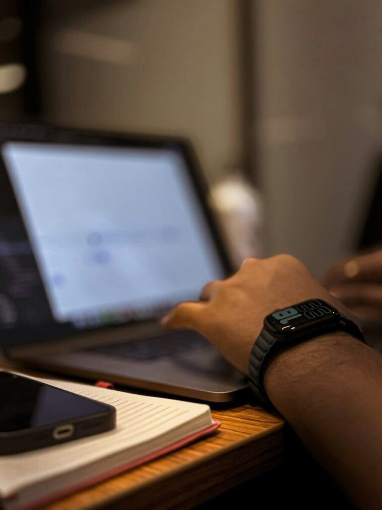 A person using a laptop computer on a desk